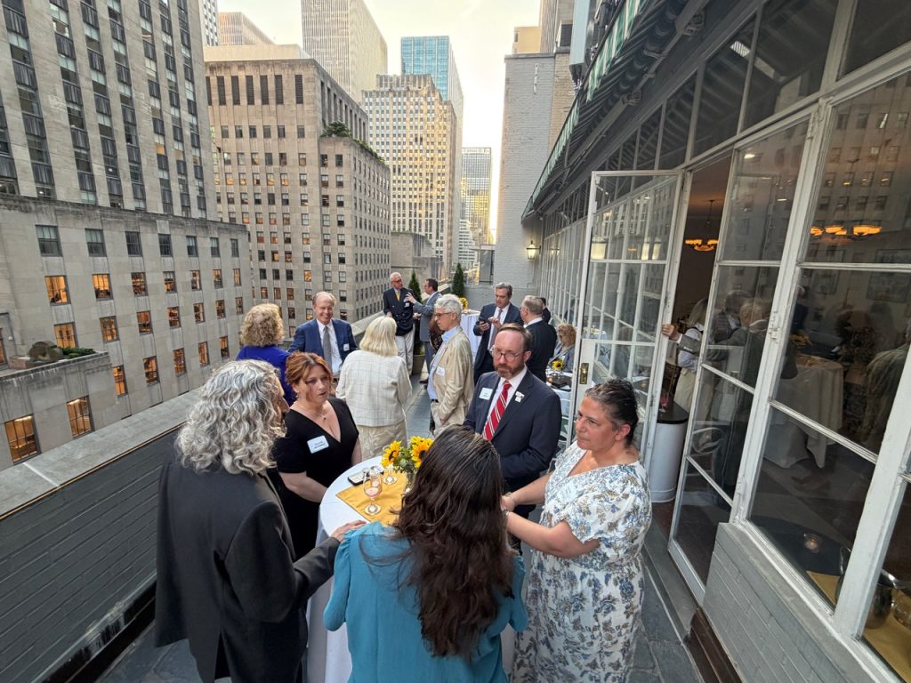 Attendees enjoy the reception overlooking Midtown Manhattan